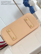 Mini tan leather bag with two gold-stud front tabs and smooth leather finish
