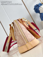 Mini monogram bag open view with gold zipper, tan leather trim and red strap