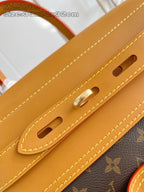 Louis Vuitton monogram handbag handle attachment with tan straps and gold-tone hardware