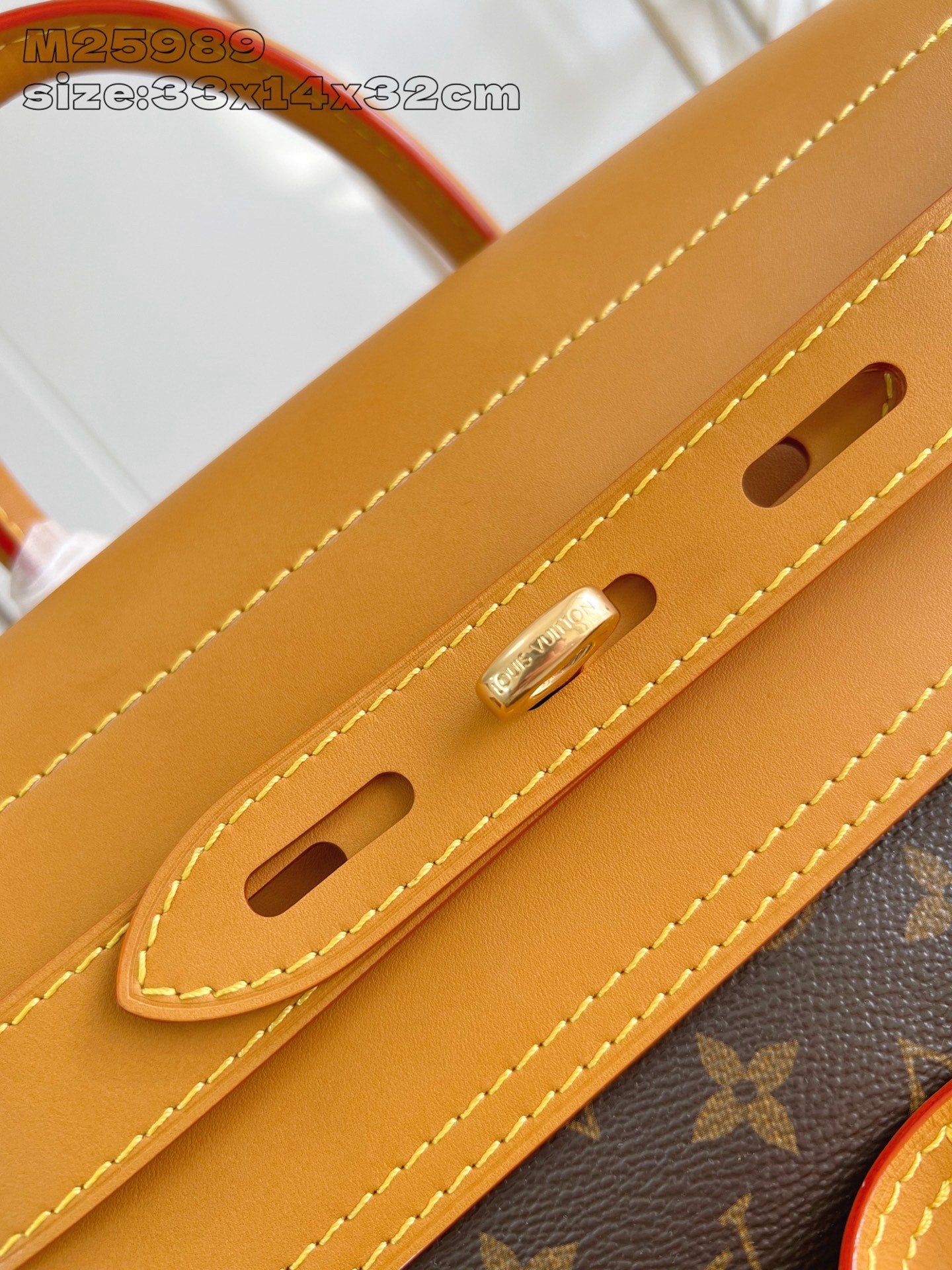 Louis Vuitton monogram handbag handle attachment with tan straps and gold-tone hardware