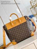 Louis Vuitton monogram handbag with structured top handles and tan leather crossbody strap