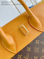 Louis Vuitton monogram handbag front corner pocket with tan leather panel and metal buckle