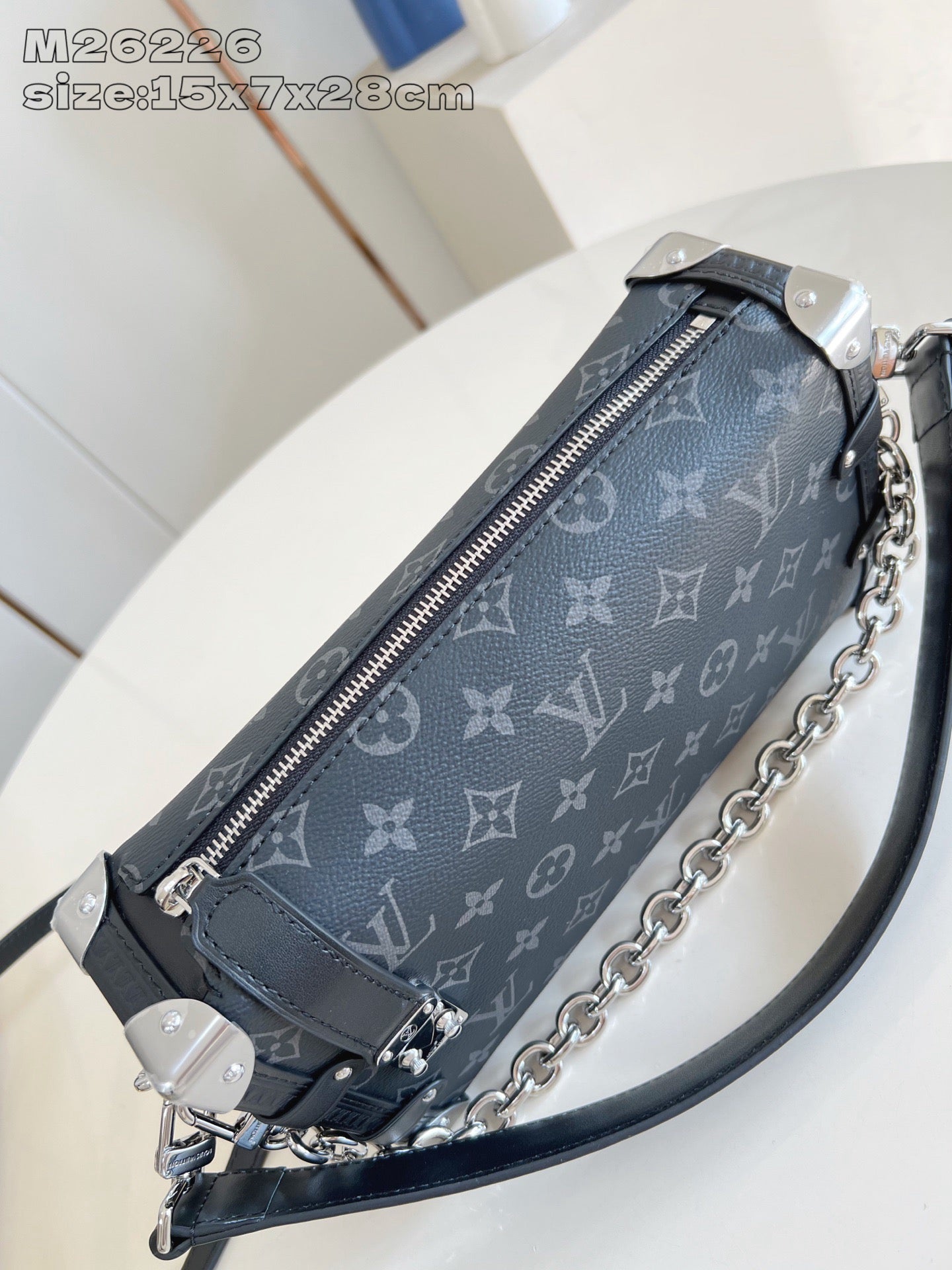 Crossbody bag: top zip slider, dark monogram fabric, chain strap and side tab