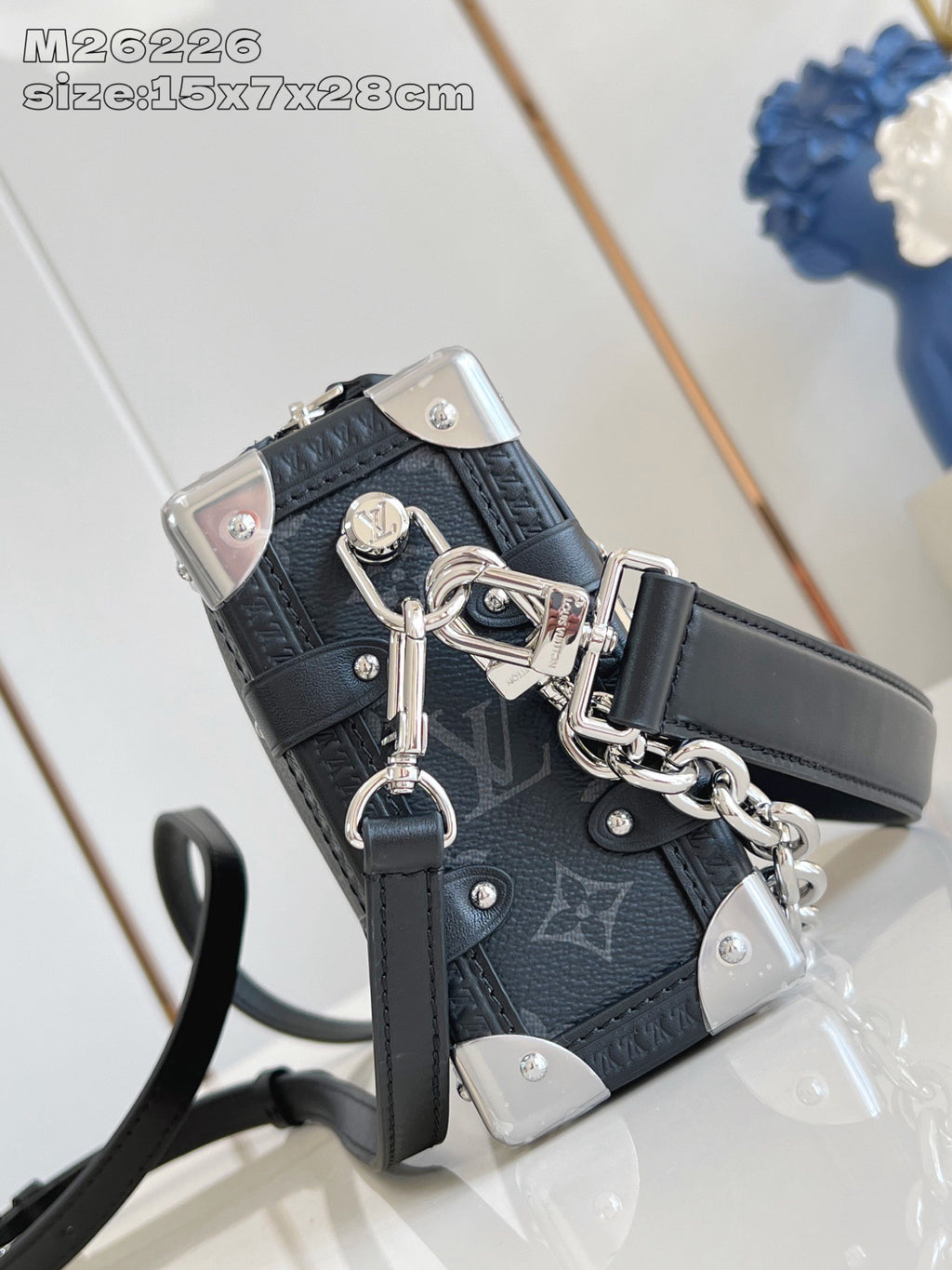 Crossbody bag corner view with chain strap and top handle hardware