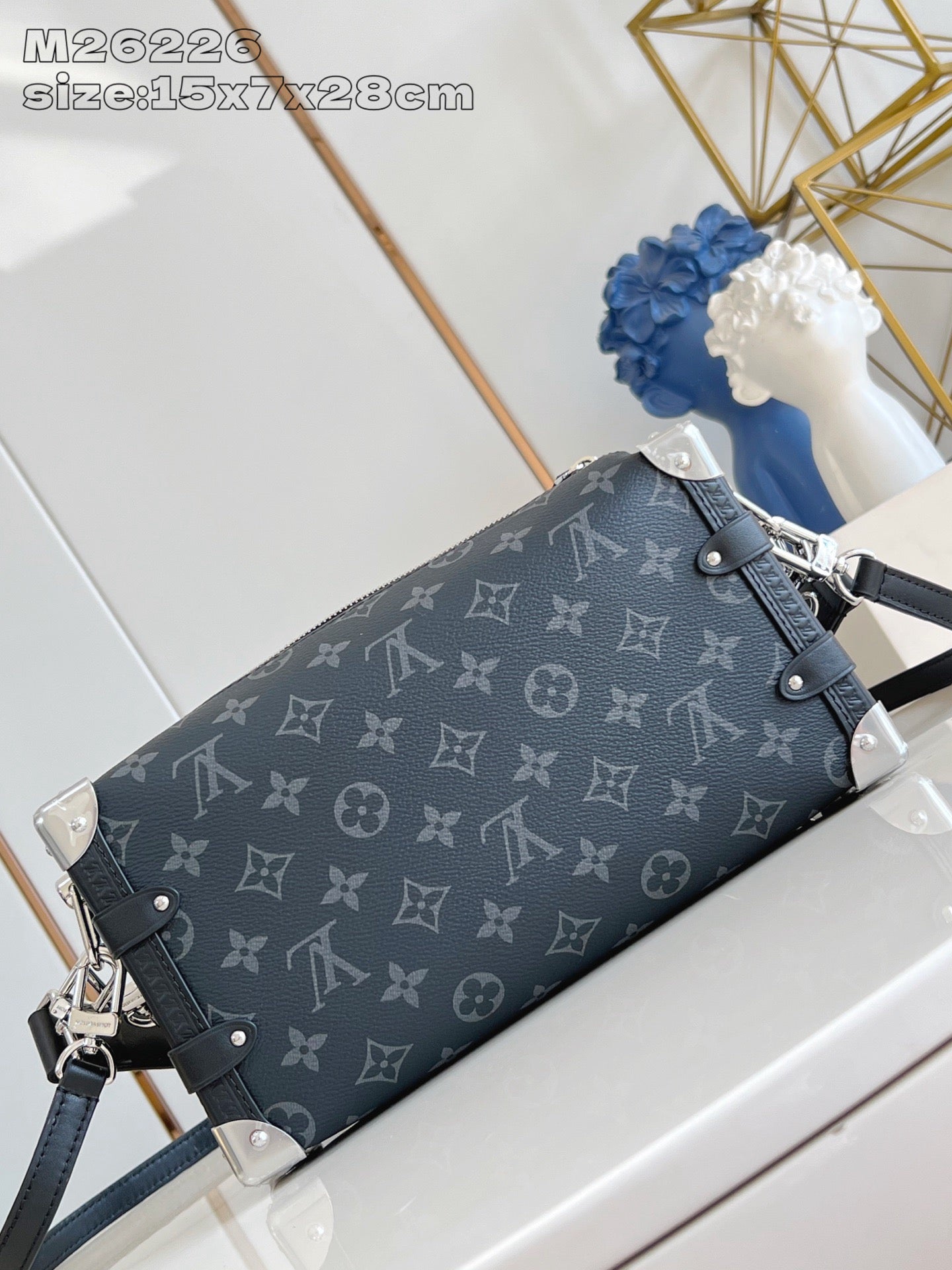 Crossbody bag with dark monogram print, flap closure, and chain shoulder strap