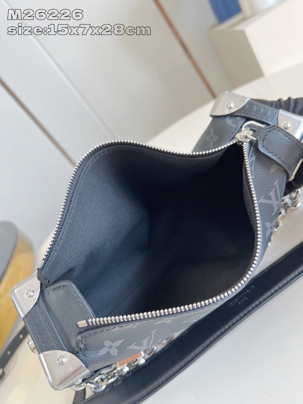 Crossbody bag open interior view with zipper opening and dark monogram lining