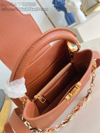 Pink pebbled leather handbag interior with gold zipper and compartments