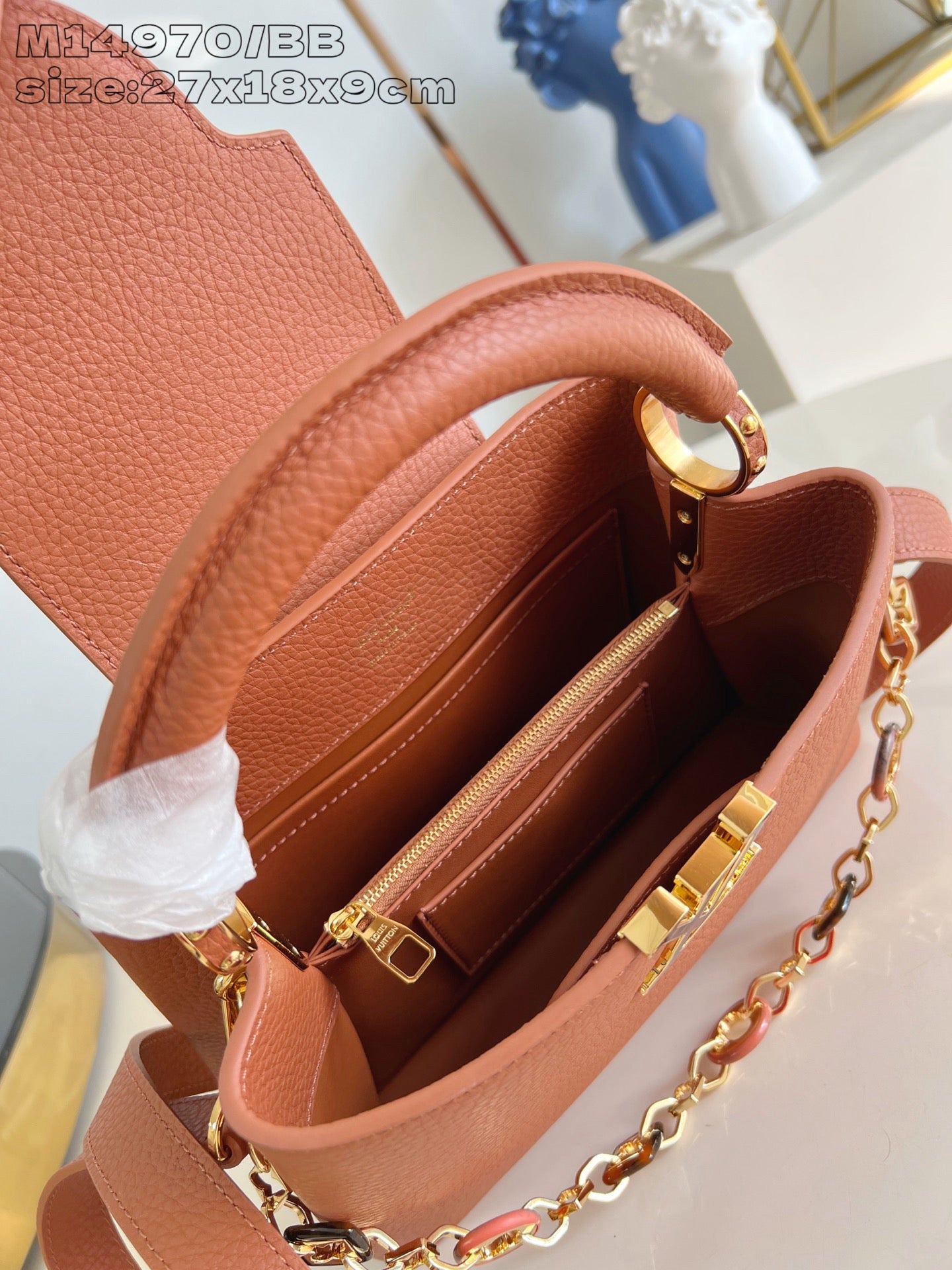 Pink pebbled leather handbag interior with gold zipper and compartments