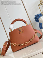 Pink pebbled leather mini handbag with top handle and shoulder strap