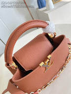 Pink pebbled leather mini bag with wrapped handle and gold chain detail