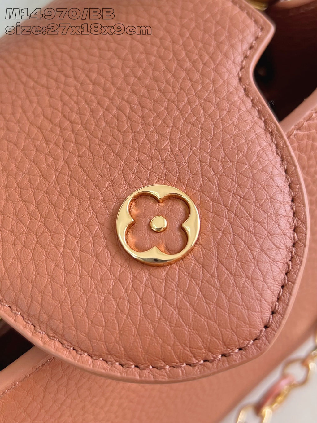 Pink pebbled leather handbag with gold snap closure detail
