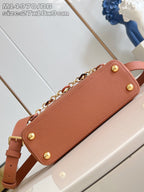 Pink pebbled leather handbag with gold button feet and chain strap