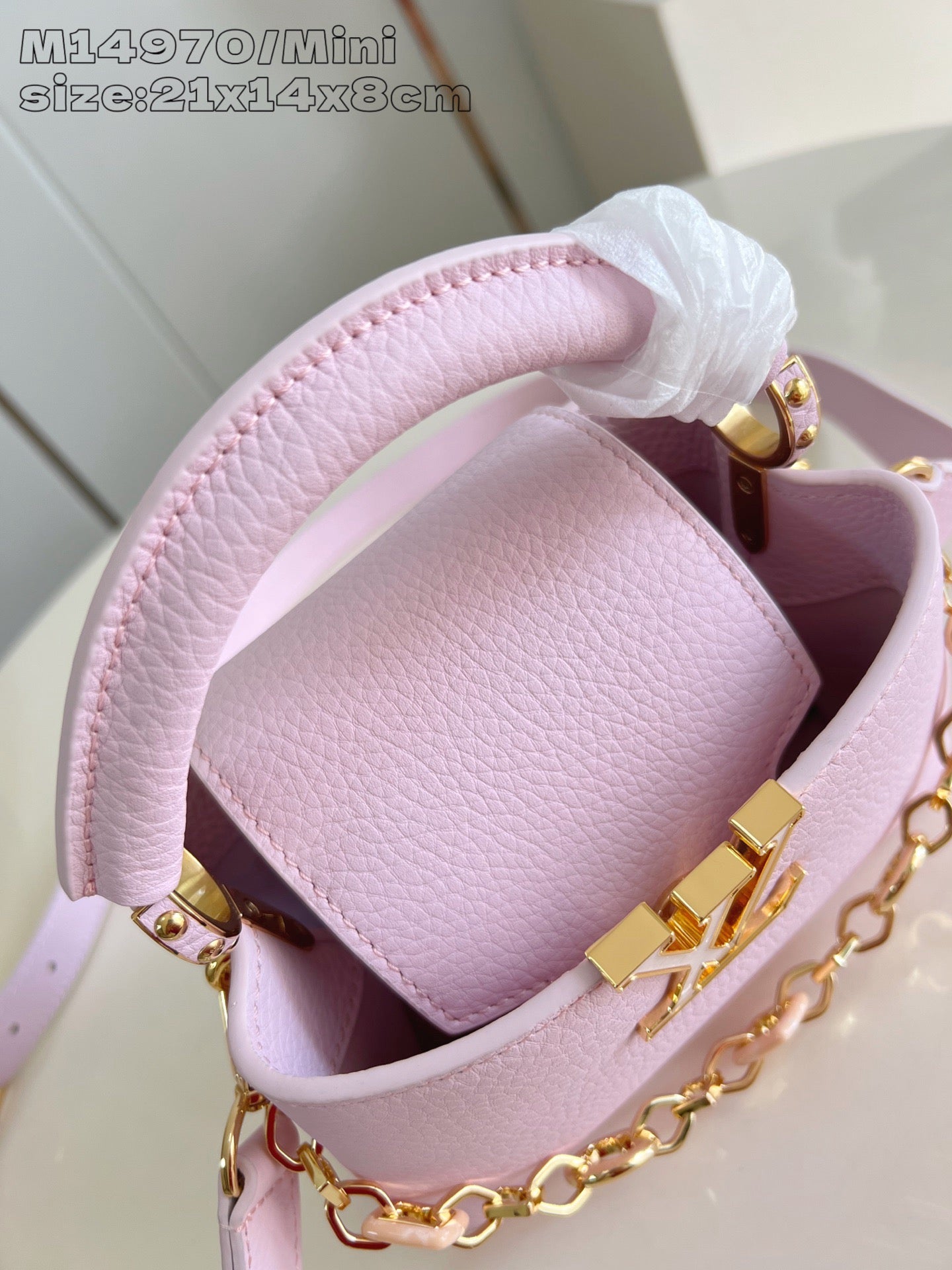 Louis Vuitton mini handbag interior in light pink leather with gold clasp hardware