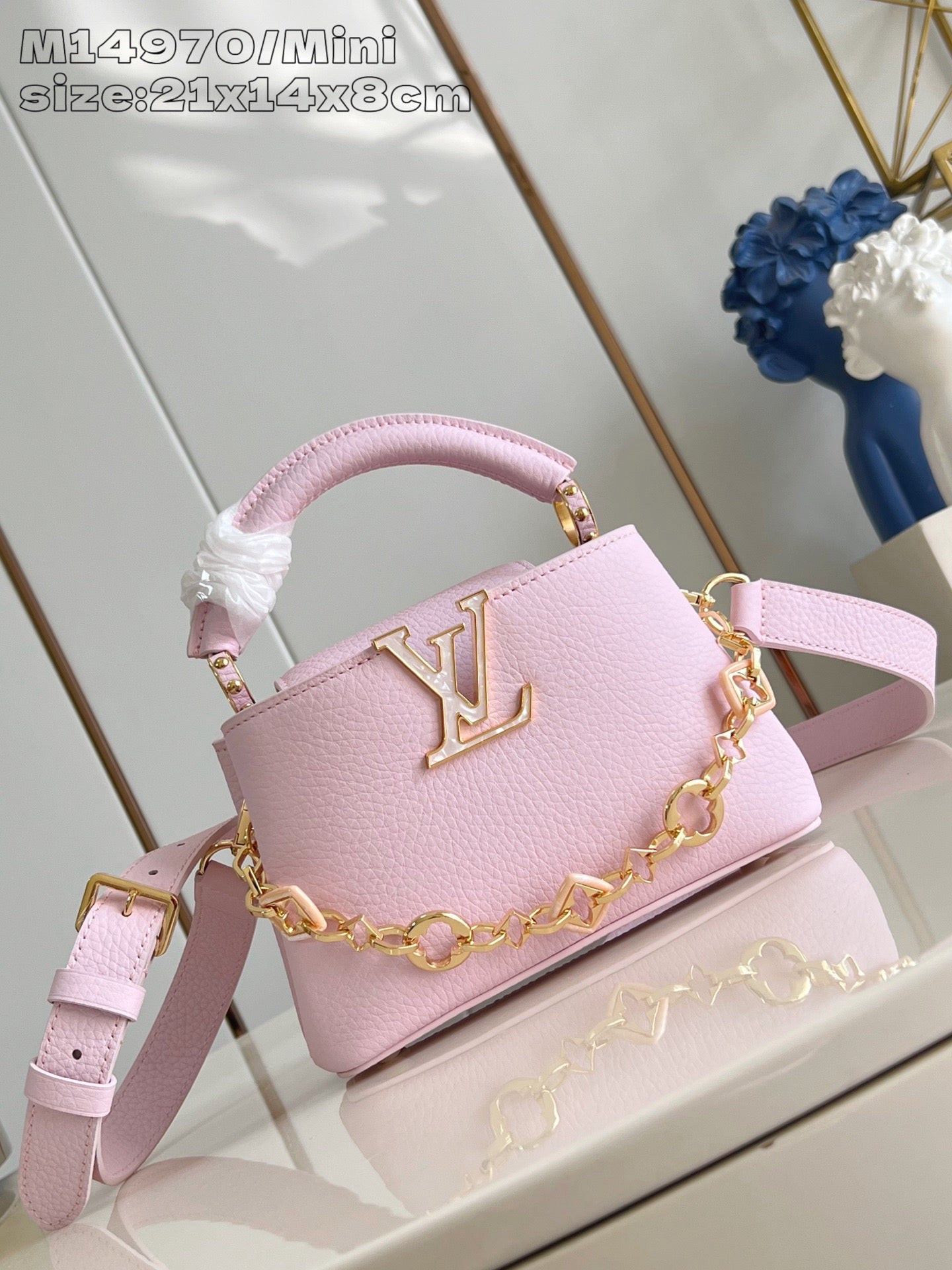 Louis Vuitton mini handbag in light pink with gold chain strap and LV logo front