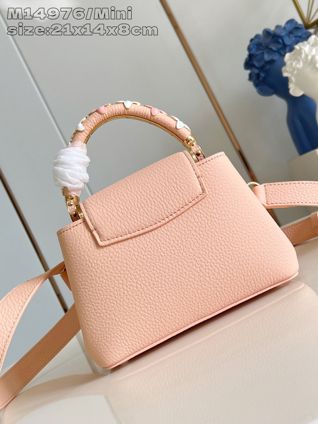 Louis Vuitton mini handbag with top handle and pink crossbody strap, gold hardware