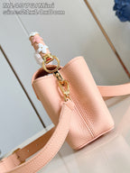 Louis Vuitton mini handbag with pink shoulder strap and gold-tone hardware