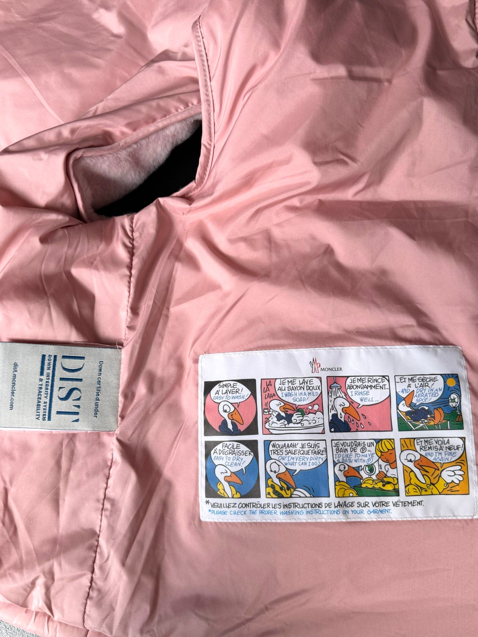 Moncler pink padded gilet label and comic-style patch on inner lining