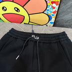 Black Prada pants waistband with drawstring cords and PRADA logo at front.