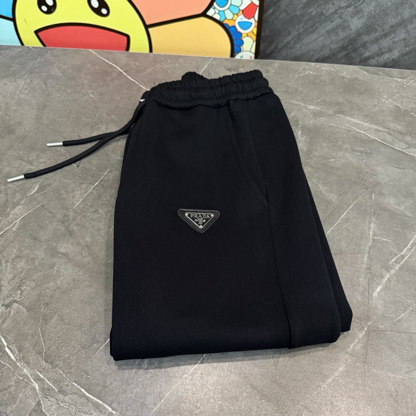 Prada black drawstring jogger pants with elastic waistband and logo patch
