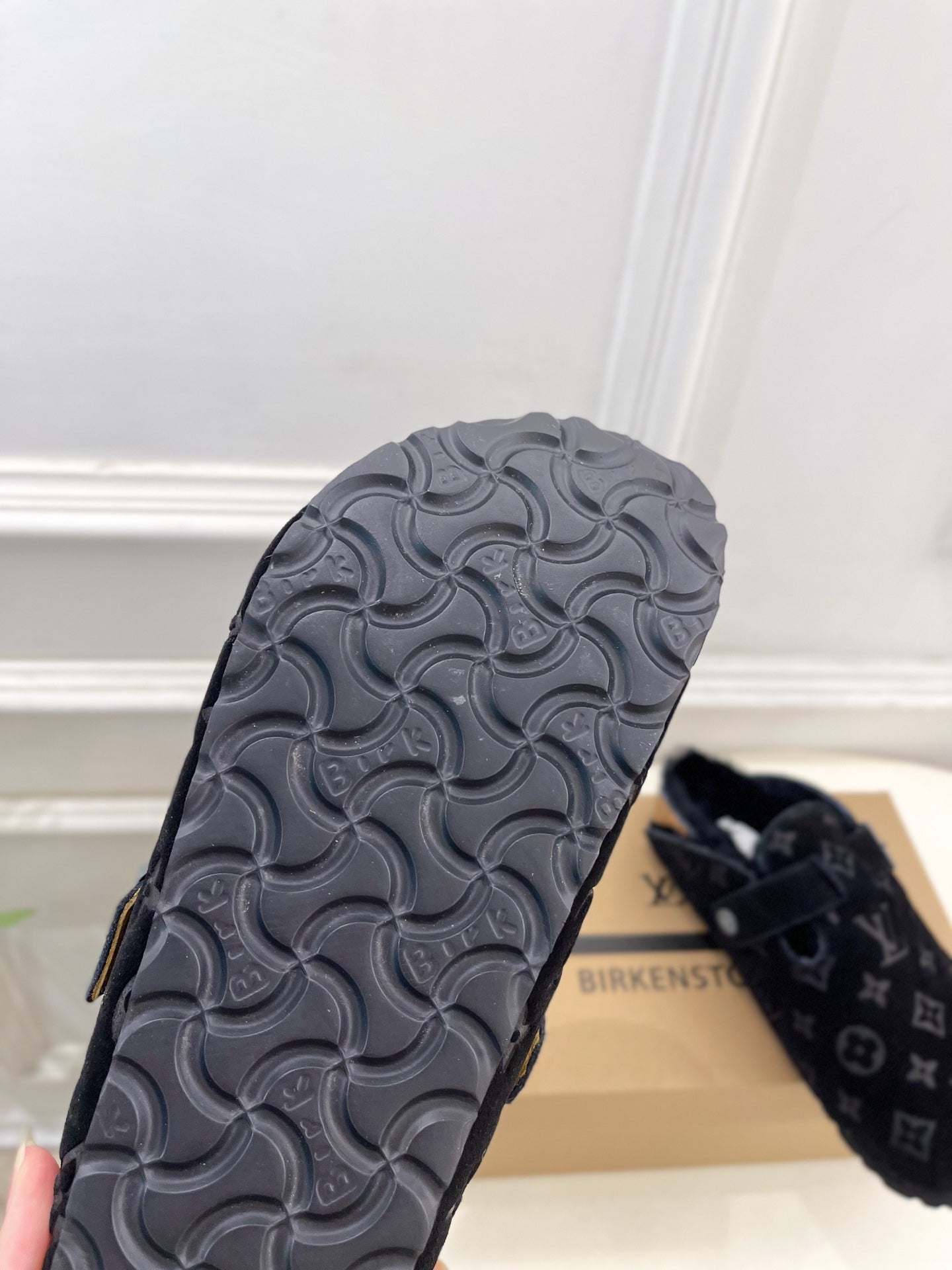 Textured rubber outsole for monogram slide sandal, molded swirl tread pattern.