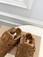 Pair of brown suede sandals with buckle straps and shearling-lined interior