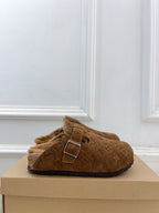 Brown suede slide sandals with adjustable buckle strap and shearling lining