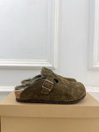 Olive green monogram slide sandal with buckle strap and shearling lining