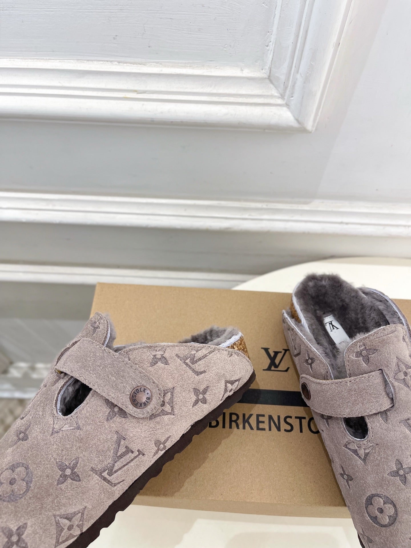 Monogram slide sandals pair in dark taupe suede with wide adjustable strap and buckle