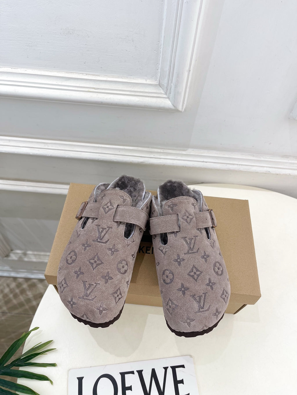 Monogram slide sandals in dark taupe suede with two straps and buckle, fuzzy lining