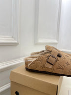 Tan Louis Vuitton monogram slide sandals with buckle strap and plush shearling side view