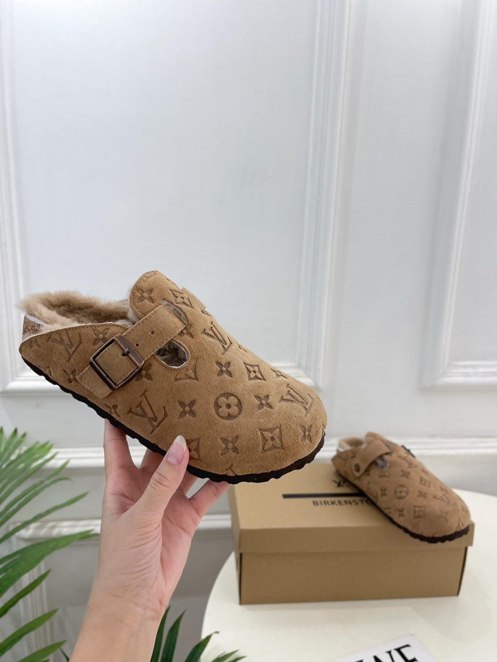 Tan Louis Vuitton monogram clog-style sandals with buckle strap and plush shearling lining