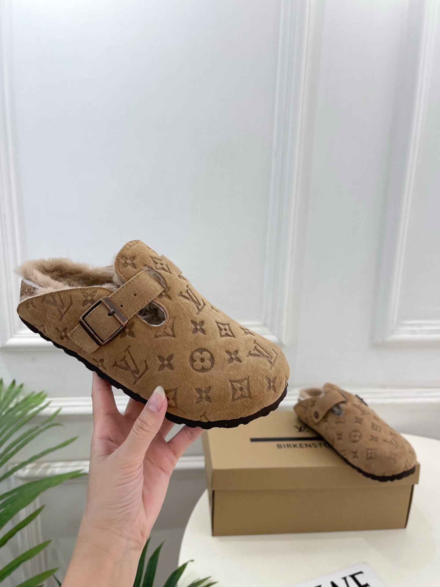 Tan Louis Vuitton monogram clog-style sandals with buckle strap and plush shearling lining