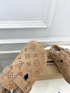 Tan Louis Vuitton monogram sandals with buckle strap and plush shearling around openings