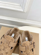 Tan Louis Vuitton monogram shearling slide sandals with two straps and buckle details