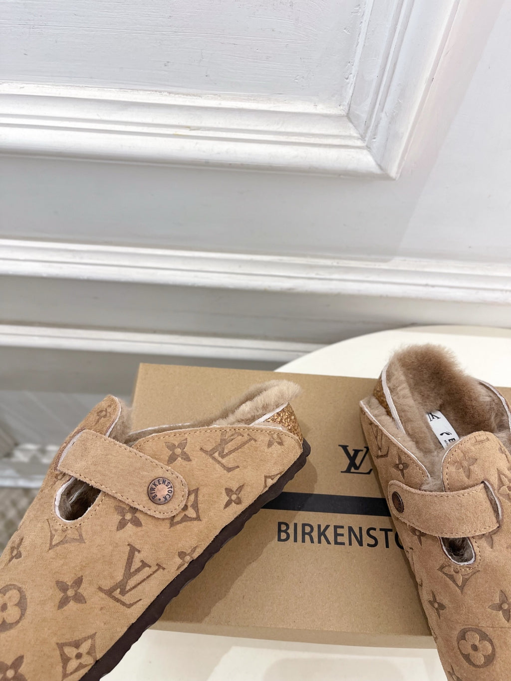 Tan Louis Vuitton monogram slide sandals with adjustable buckle and shearling-lined interior