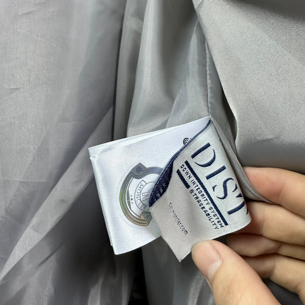 Long puffer jacket care label tags attached near inner hem