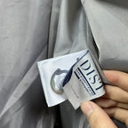 Long puffer jacket care label tags attached near inner hem