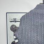 Long puffer jacket back knit collar with cable pattern and dark puffer edge.