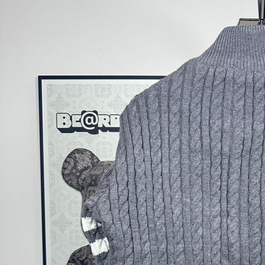 Long puffer jacket back knit collar with cable pattern and dark puffer edge.