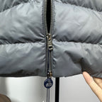 Long puffer jacket with front zipper and hanging metal pull tab