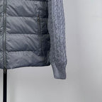 Long puffer jacket quilted dark body panel with zipper and seam detail.