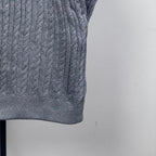 Long puffer jacket sleeve cuff in gray cable-knit with ribbed hem.
