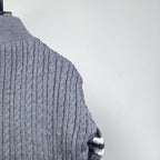 Long puffer jacket back upper knit with ribbed stand collar and cable pattern.