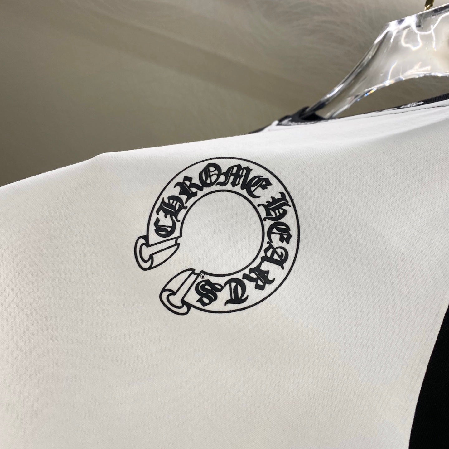 White T-shirt back with partial circular logo graphic