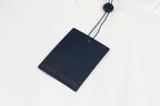 White long-sleeve sweatshirt with Louis Vuitton hang tag tied to neck