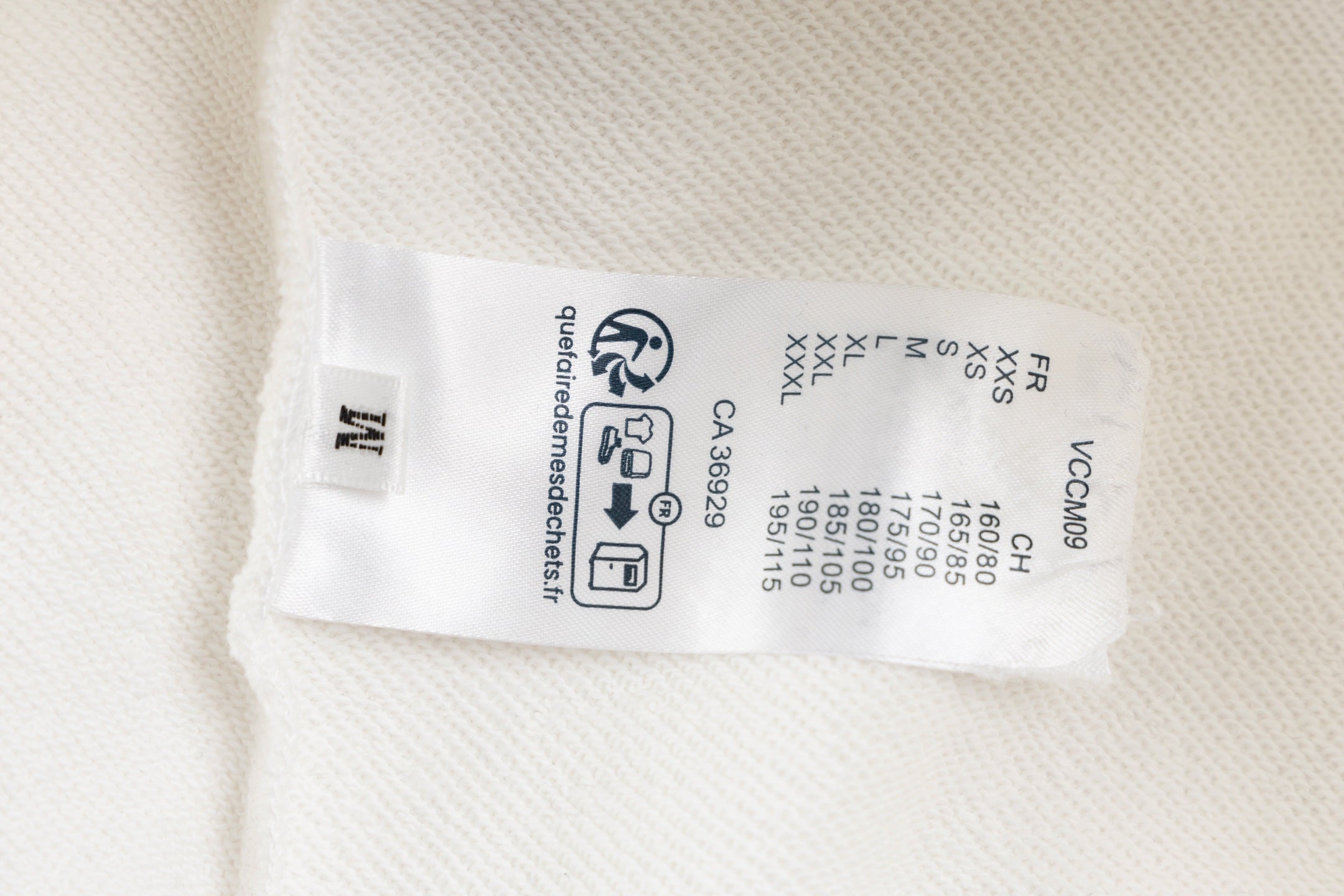 White long-sleeve sweatshirt care label with size and fabric info