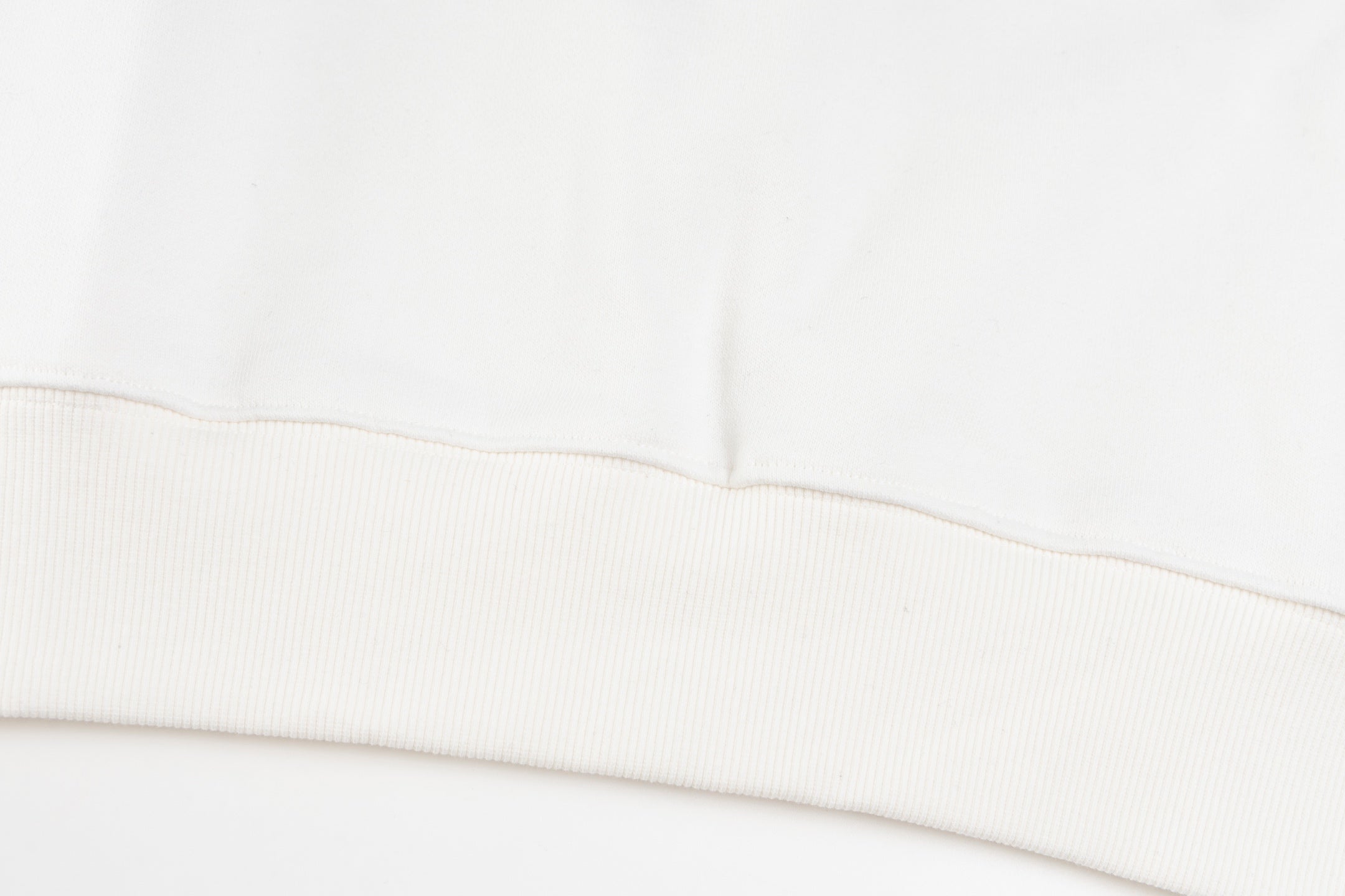 White long-sleeve sweatshirt ribbed hem with double-stitching detail