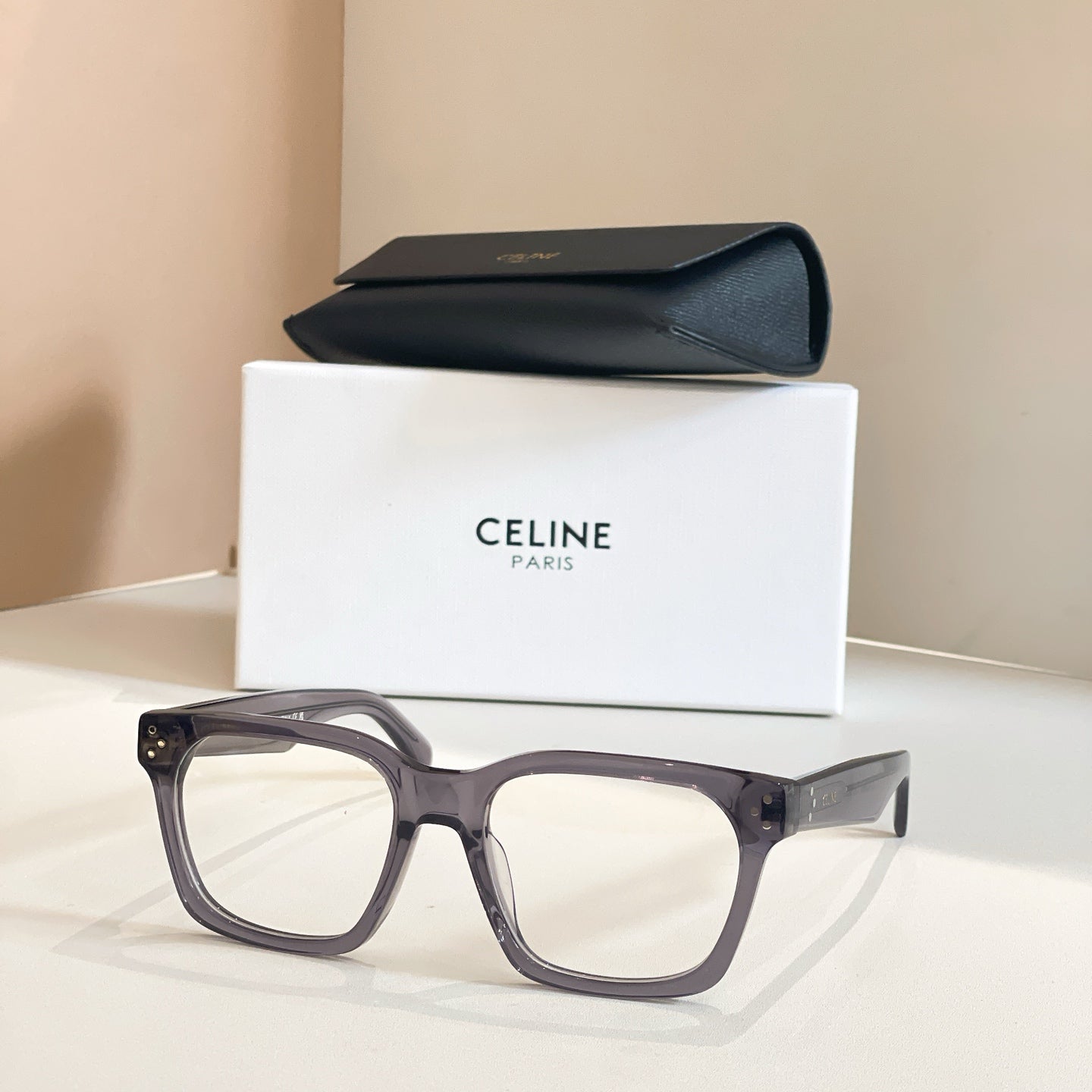 Celine glasses with gray square frames and clear lenses.