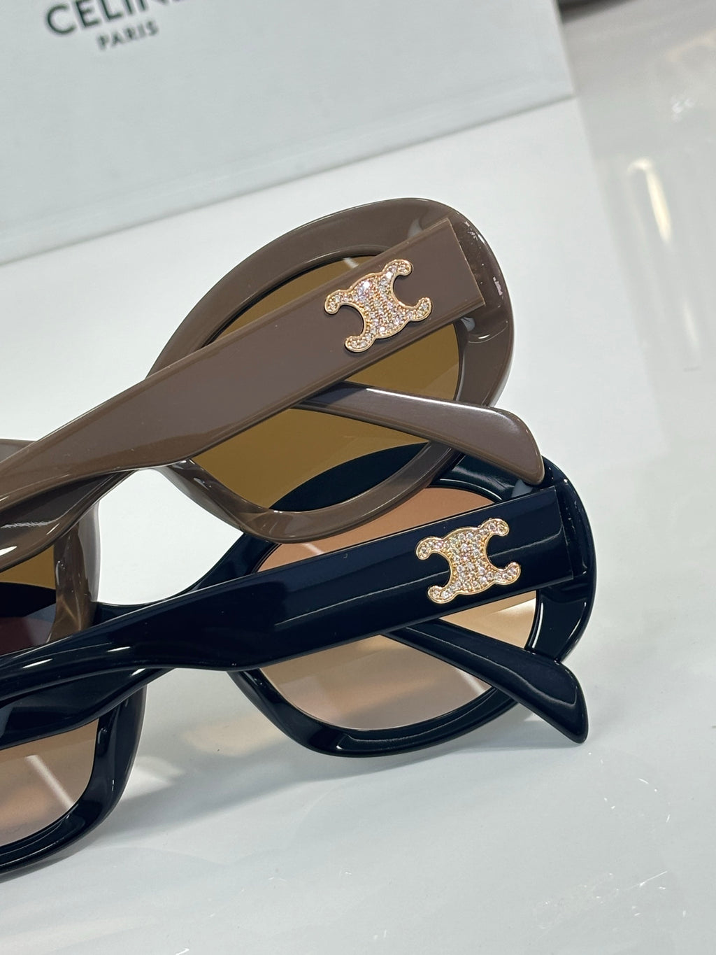Celine sunglasses temples with gold logo and dark lenses on blue and brown frames