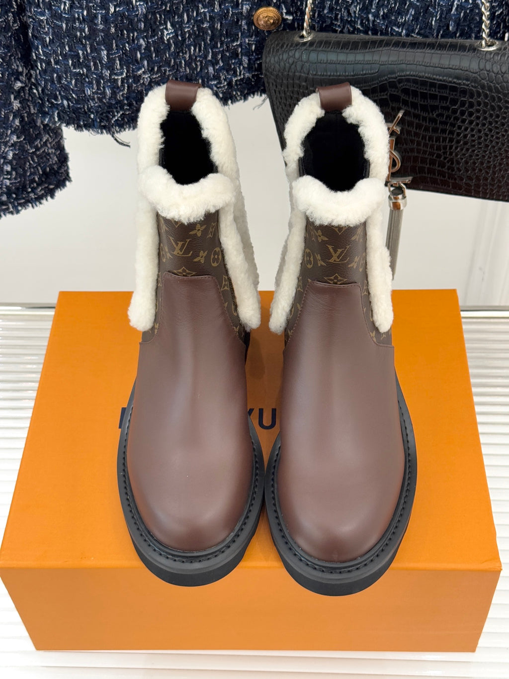 Brown Louis Vuitton ladies ankle boots with white sherpa trim and monogram sides